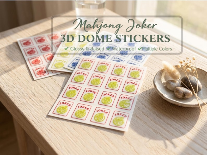 May include: Sheets of 3D dome stickers for Mahjong Joker, featuring glossy, raised, and waterproof designs in multiple colors. The stickers have a red border and a yellow and green design. The text "JOKER" is visible.