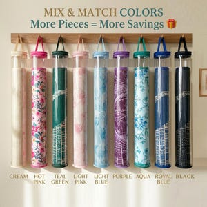 May include: Nine cylindrical clear plastic storage tubes hanging from a wooden rack, each containing a rolled fabric item in various colours and patterns labelled as cream, hot pink, teal green, light pink, light blue, purple, aqua, royal blue, and black.