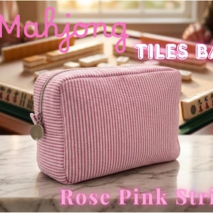 May include: A rose pink striped Mahjong Tiles Bag with a silver zipper and charm. The bag is rectangular and sits on a marble surface. The words "Mahjong TILES BAG" and "Rose Pink Stripe" are written on the image.