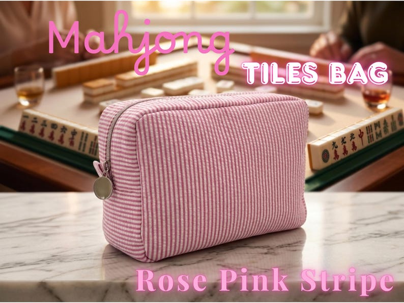 May include: A rose pink striped Mahjong Tiles Bag with a silver zipper and charm. The bag is rectangular and sits on a marble surface. The words "Mahjong TILES BAG" and "Rose Pink Stripe" are written on the image.