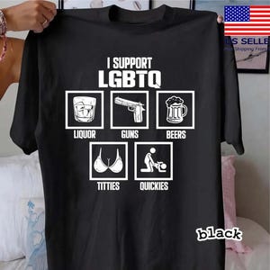 May include: Black t-shirt with the text "I Support LGBTQ" and images of liquor, guns, beers, breasts, and sexual activity. The word "black" is printed at the bottom right corner of the shirt.