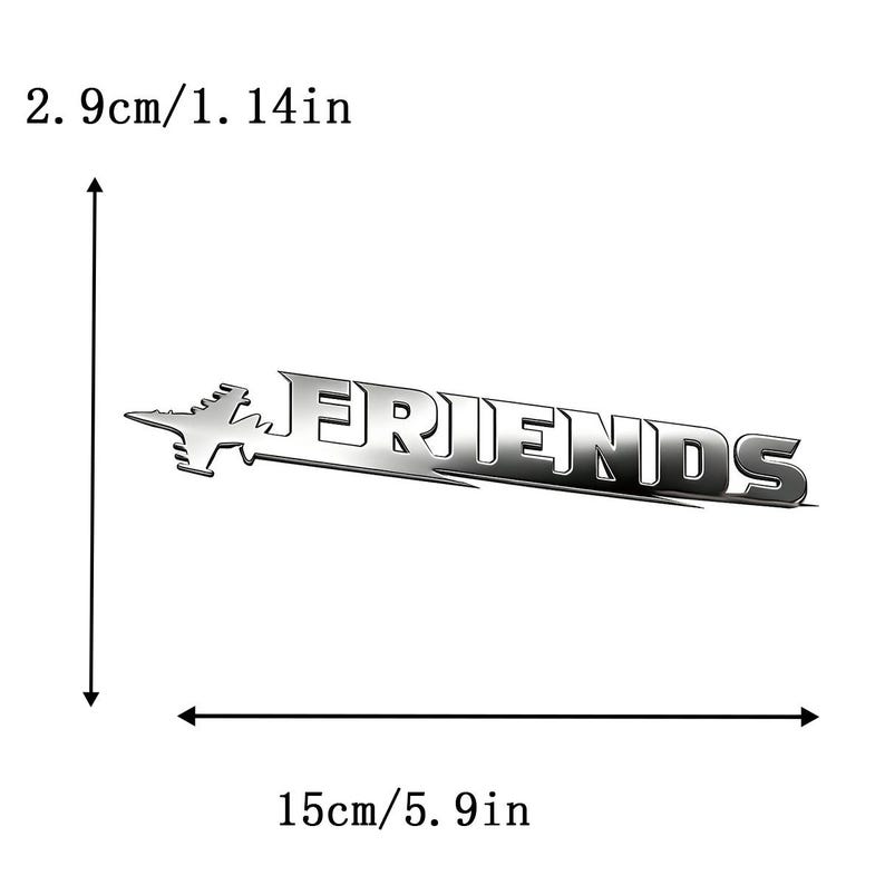 May include: A silver metal emblem featuring the word "FRIENDS" in a stylized font, with a jet plane silhouette. The emblem is 15cm wide and 2.9cm high.