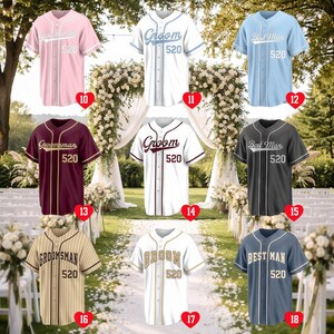 May include: A collection of eight button-down baseball jerseys in various colors including pink, white, light blue, maroon, gray, and tan pinstripe. Each jersey features the text Groomsman, Groom, or Best Man with the number 520 printed on the front.