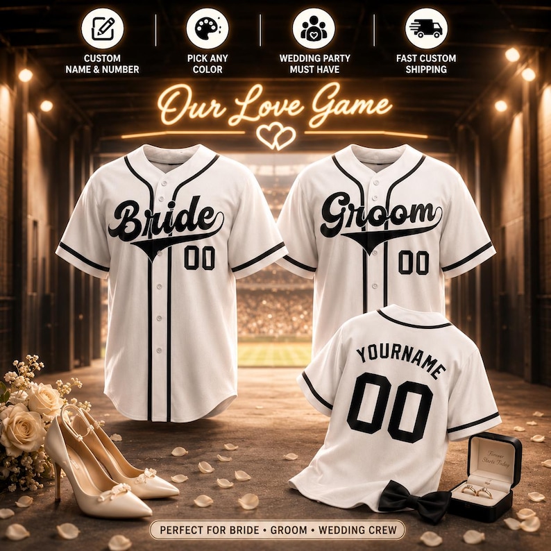 May include: Three white baseball jerseys with black trim and buttons. Two jerseys feature the text Bride and Groom with the number 00. The third jersey displays the text YOURNAME and the number 00. The text Our Love Game is visible above.