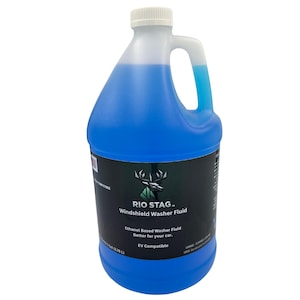 May include: A blue plastic jug of Rio Stag Windshield Washer Fluid. The jug has a white cap and handle. The label includes the text "Ethanol Based Washer Fluid Better for your car. EV Compatible."