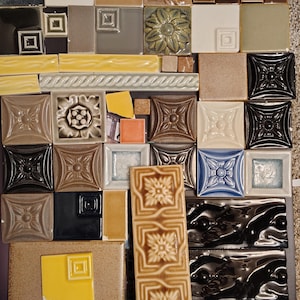 40 Pieces of chipped, broken or irregular ceramic tile.  assorted colors and shapes.