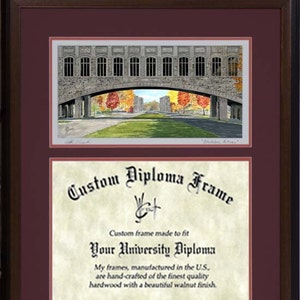 May include: A framed print of a stone bridge with fall foliage, above a diploma frame. The print features a detailed watercolor painting of a bridge with arched openings. The diploma frame has the text "Custom Diploma Frame".