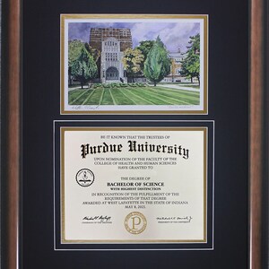 May include: Framed Purdue University diploma and watercolor print of a campus building. The diploma is for a Bachelor of Science degree with highest distinction, awarded May 8, 2021. The frame is brown with a black matting.