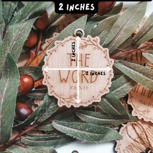 May include: A set of wooden ornaments with a variety of religious phrases, including "The Word", "Light", and "Faith". Each ornament measures a little over 2 inches in diameter. The ornaments are made of natural wood and have a rustic, hand-crafted look.