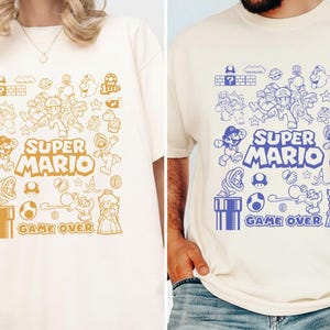 Camiseta con arte de garabatos de Mario y sus amigos Camiseta de la película Mario Galaxy Camiseta de la familia Super Mario Camiseta de los videojuegos de Disneyland Mario Camiseta del universo épico imagen 2