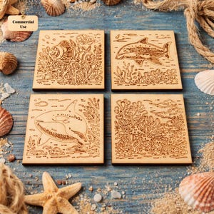 May include: Set of four square wooden coasters with engraved marine life designs. Each coaster features a different sea creature: a clownfish, a dolphin, a killer whale, and a coral reef scene. The coasters are light brown in color.