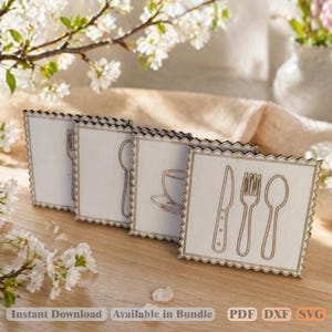 May include: Four wooden coasters with a white background and a dark brown border. Each coaster features a different utensil design: a fork, spoon, teacup, knife, fork, and spoon. The coasters are arranged on a light brown wooden surface.
