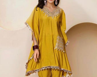 Women Embellished Tunic, has a V-neck and three-quarter sleeves With Trousers