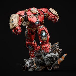 May include: A red and gold action figure of a robotic character, posed on a rocky base with debris. The figure has a detailed design with visible mechanical components and glowing blue accents. The figure is approximately 30 cm tall.