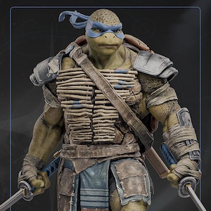 May include: A detailed figurine of Leonardo, a Teenage Mutant Ninja Turtle, in a battle-ready pose. He wears a blue mask, armor, and carries two katanas. The figure has a textured, realistic appearance with intricate details.