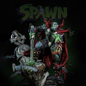 May include: A detailed Spawn action figure, posed dynamically with a sword and shield. The figure is predominantly blue, black, and red, with skull accents and a flowing red cape. The figure is set against a backdrop with the word "Spawn" in green and purple.