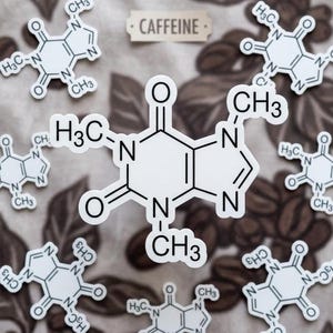 May include: White caffeine molecule stickers with the word "CAFFEINE" on a brown background. The stickers feature the chemical structure of caffeine, with labels like "CH3" and "N". The background has a coffee bean pattern.