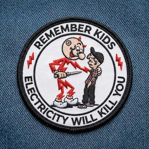 May include: A circular embroidered patch with a white background and black border. It features a cartoon character made of red lightning bolts holding a knife, standing next to a child. The text reads REMEMBER KIDS ELECTRICITY WILL KILL YOU.