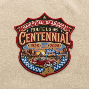 May include: A shield-shaped embroidered patch featuring the text MAIN STREET OF AMERICA ROUTE US 66 CENTENNIAL 1926 2026. The design depicts a red vintage car on a desert road, a motel sign, and rock formations in a sunset landscape with a checkered border.