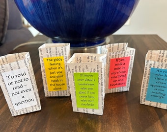 May include: Five small, folded paper boxes with different coloured sticky notes attached. The notes have text about reading, including "To read or not to read - not even a question", "The giddy feeling when it's just you and your book in the house alone", "If you've ever dated a bookworm, else you glare. If you never have, raise your standards", "If you walk a mile in my shoes, you'll end up at a bookstore", and "Anyone who has time to clean apparently is not reading enough."
