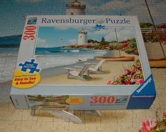 COMPLETE- Ravensburger 300 Pc. Jigsaw Puzzle - "Sunlit Shores" Beach, Lighthouse