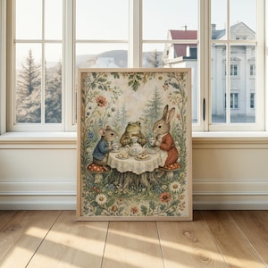 May include: A framed print depicts a whimsical tea party scene. A mouse, frog, and rabbit are gathered around a table set with a teapot and teacups. The scene is surrounded by flowers and foliage, with a light wood frame.