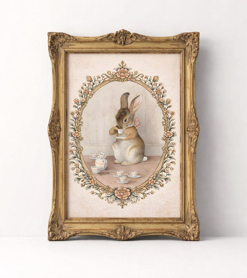 May include: A framed print featuring a watercolor illustration of a rabbit enjoying tea. The rabbit is inside an oval floral frame, surrounded by teacups and a teapot. The ornate gold frame adds a vintage touch to the artwork.