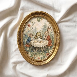 May include: An oval, gold-framed artwork depicts a tea party scene with anthropomorphic animals. A mouse, frog, and rabbit are seated around a table set on a tree stump, enjoying tea. The background features a floral and forest landscape.