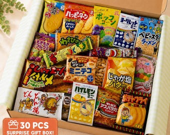 May include: A cardboard gift box filled with 30 assorted Japanese snack packages. The collection includes various colourful bags of chips, biscuits, candies, and crackers with Japanese text and cartoon illustrations, all neatly arranged inside.