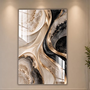 May include: A vertical rectangular wall art piece featuring an abstract fluid design with swirling patterns of cream, white, black, and grey. The composition includes prominent metallic gold veins and textured accents that create a layered effect.