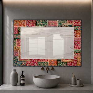 May include: A rectangular wall mirror featuring a decorative border composed of colorful, intricate floral and geometric patterns in shades of red, green, orange, and blue, surrounding a clear, reflective glass surface with a subtle marble-like texture.