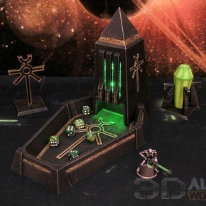 May include: A dark gray, pyramid-shaped dice tower with glowing green accents and a matching tray. The set includes a separate cross-shaped marker, a green crystal pillar, and a small metallic figurine. Several green dice are inside the tray.