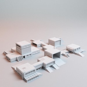May include: A collection of unpainted light gray modular building components for tabletop gaming. The set includes various rectangular structures, connecting corridors, ramps, and staircases, all featuring geometric paneling and industrial details.