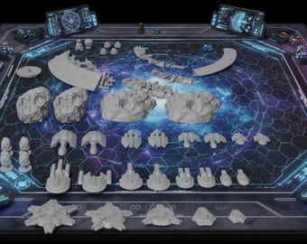 May include: A tabletop board game set featuring a dark blue hexagonal grid playmat with space-themed graphics, numerous unpainted grey miniature starships, asteroid-like terrain pieces, and small digital-style display screens at the corners.