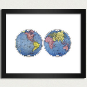 May include: A vintage world map print in a black frame. The map is divided into two hemispheres, showing North and South America on the left and Europe, Asia, Africa, and Australia on the right. The map is colored in shades of blue, yellow, red, and green.