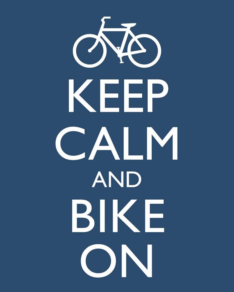 May include: White text on a blue background reads "Keep Calm and Bike On". A white silhouette of a bicycle is above the text.