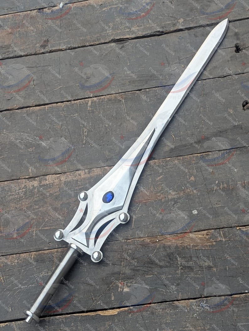 May include: A silver sword with a blue gem on the hilt. The blade is long and pointed, and the handle features decorative details. The sword is displayed on a weathered wooden surface.