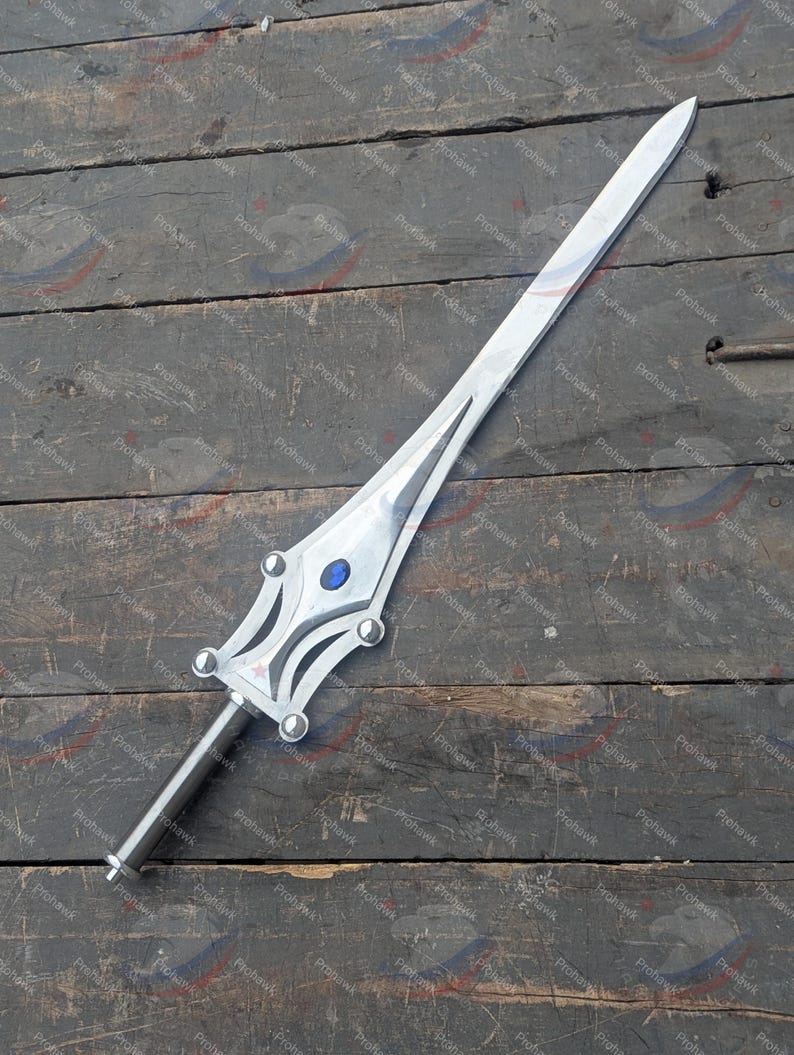 May include: A silver sword with a long, straight blade. The hilt has a decorative design with a blue gem. The sword is displayed on a weathered wooden surface.