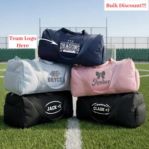 May include: A stack of personalized duffel bags in various colors, including navy, light gray, pink, and black. Each bag features custom text and graphics, such as names, team logos, and a bow. The text "Bulk Discount!!!" is visible.