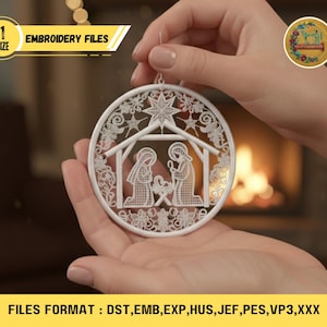 May include: A white, circular Christmas ornament featuring a nativity scene with a star and floral details. The ornament is held by a person. The text "EMBROIDERY FILES" and "SIZE" are visible. The file formats are listed at the bottom.