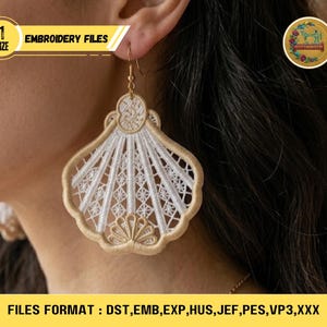 May include: A close-up of a gold and white embroidered earring in a fan shape. The earring is attached to a gold hook. The text "EMBROIDERY FILES" and "SIZE" are visible. The bottom of the image displays "FILES FORMAT: DST, EMB, EXP, HUS, JEF, PES, VP3, XXX".