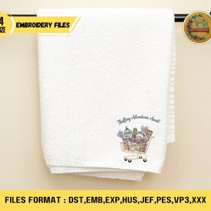 May include: White folded towel with an embroidered shopping cart design filled with various items. The text "Thrifting Adventures Await!" is above the cart. The towel is hanging on a black towel rack. The image also includes text that says "4 SIZE EMBROIDERY FILES".