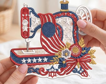 Op de afbeelding: Geborduurde naaimachine-applicatie in rood, wit en blauw, met sterren en strepen. Het ontwerp bevat bloemaccenten en een decoratieve strik. De applicatie wordt door een persoon vastgehouden.