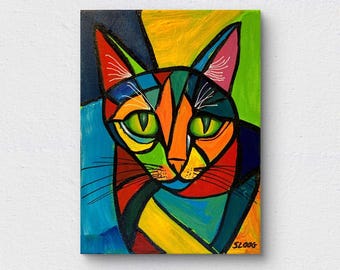May include: An abstract painting of a cat's face, rendered in a mosaic style. The artwork uses a palette of bright colours including orange, green, blue, yellow, and red. The cat's eyes are green, and the painting is signed "SLOOG" in the bottom right corner.