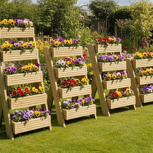 May include: Four tiered wooden plant stands arranged in a row on a green lawn. Each stand features multiple horizontal slatted wooden boxes filled with colourful pansy flowers in shades of yellow, purple, red, and white, creating a vertical garden.