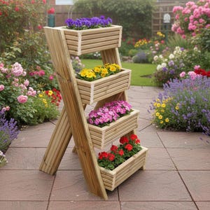 May include: A wooden plant stand with four rectangular planters, each holding colourful flowers. The stand is angled and set on a stone patio, surrounded by a vibrant garden with various flowers and greenery.