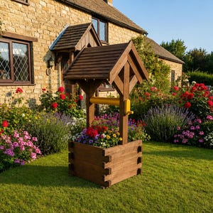 May include: A wooden wishing well planter, filled with colourful flowers, stands on a green lawn in front of a stone house. The well has a brown roof and a yellow handle. Red, pink, and purple flowers surround the well.