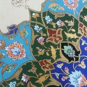 May include: Close-up of a detailed floral pattern in shades of blue, green, red, and gold. The design features stylized flowers and leaves, with intricate details and a symmetrical arrangement. The background is a cream color.