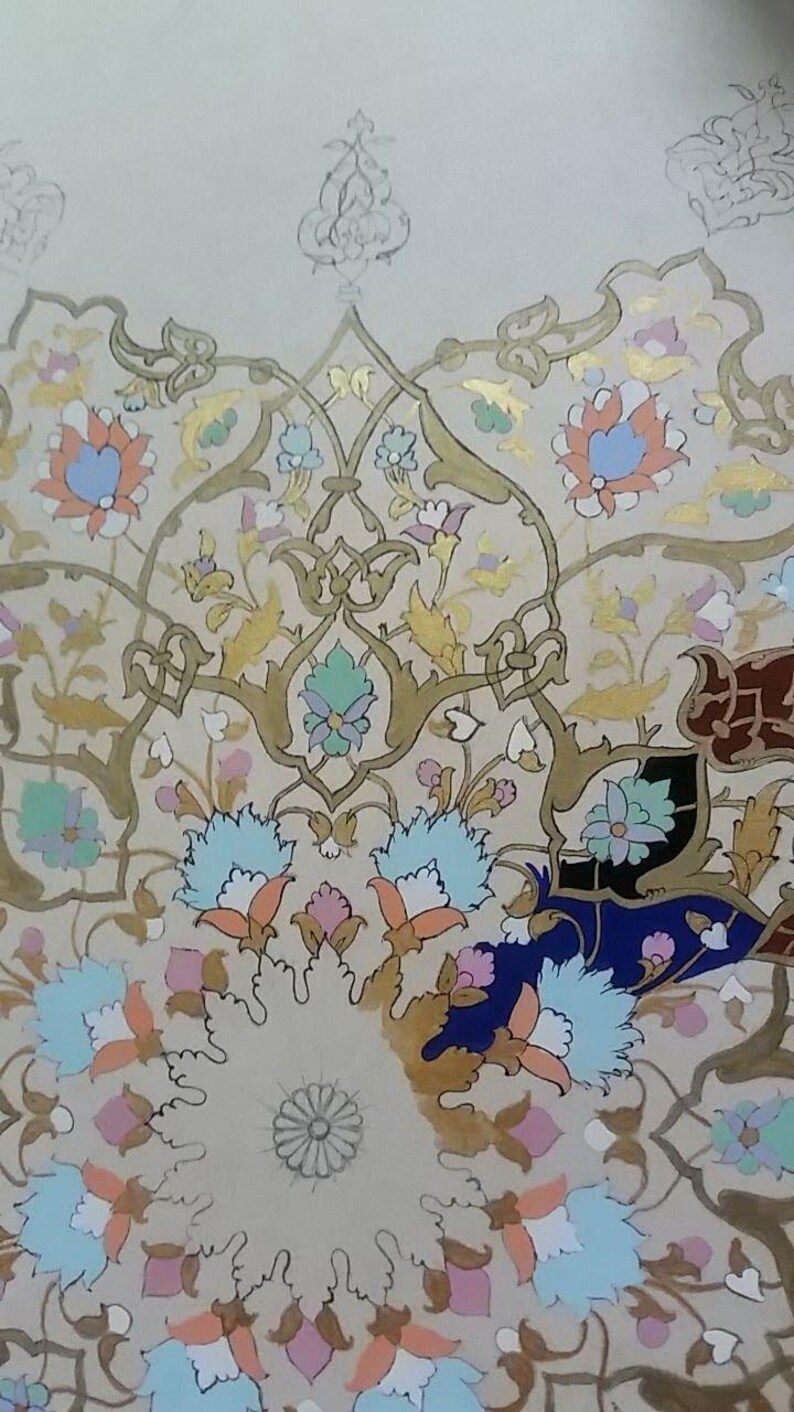 May include: An intricate floral design in a circular pattern. The artwork features a beige background with detailed gold, blue, pink, and orange floral elements. The design has a symmetrical arrangement with a central floral motif.