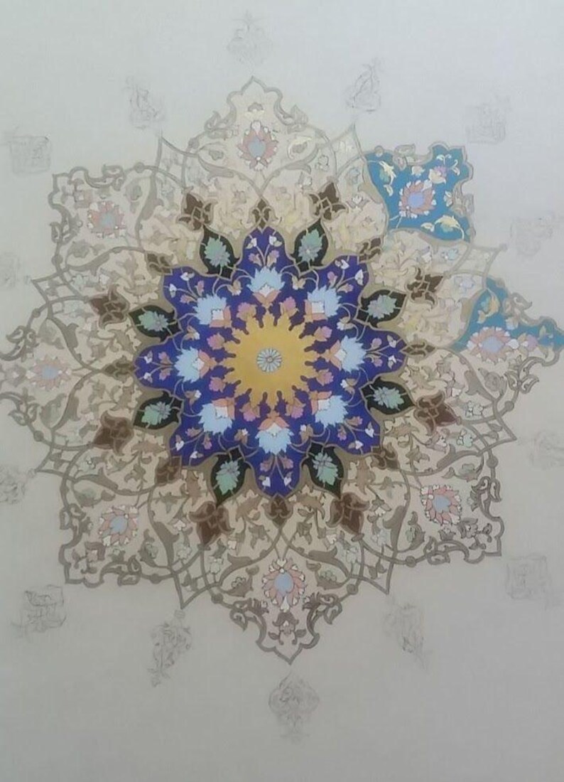 May include: A detailed, symmetrical floral design in shades of blue, yellow, and beige. The central motif is a large, stylized flower with intricate petal patterns. The background is a light, neutral color, enhancing the design's prominence.